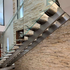 Stainless steel stair with granite treads and glass balustrade